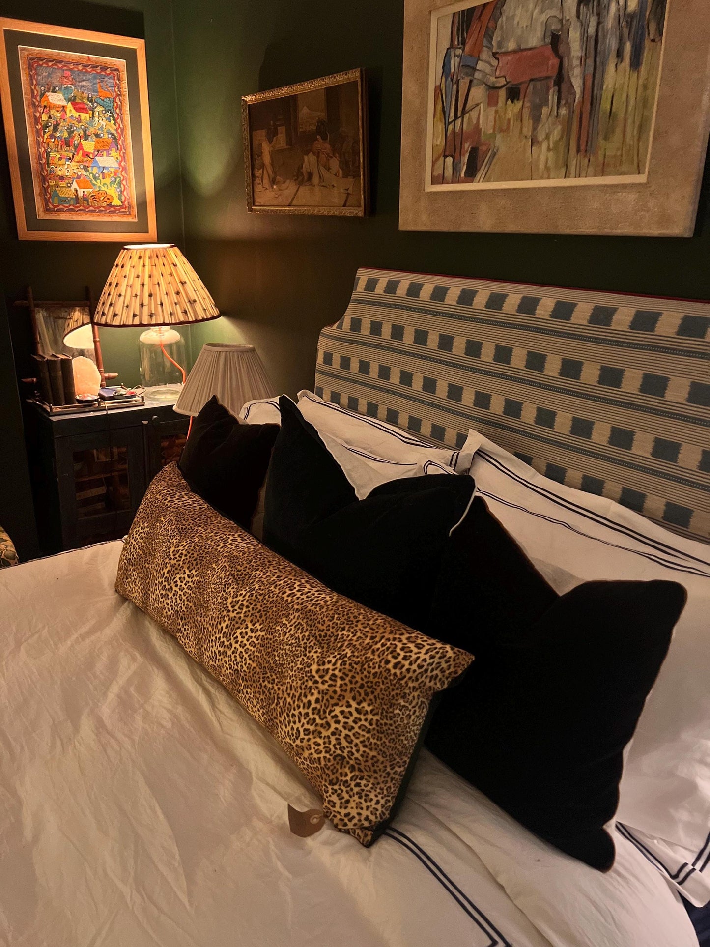 Large leopard print bolster cushions backed with green velvet backing