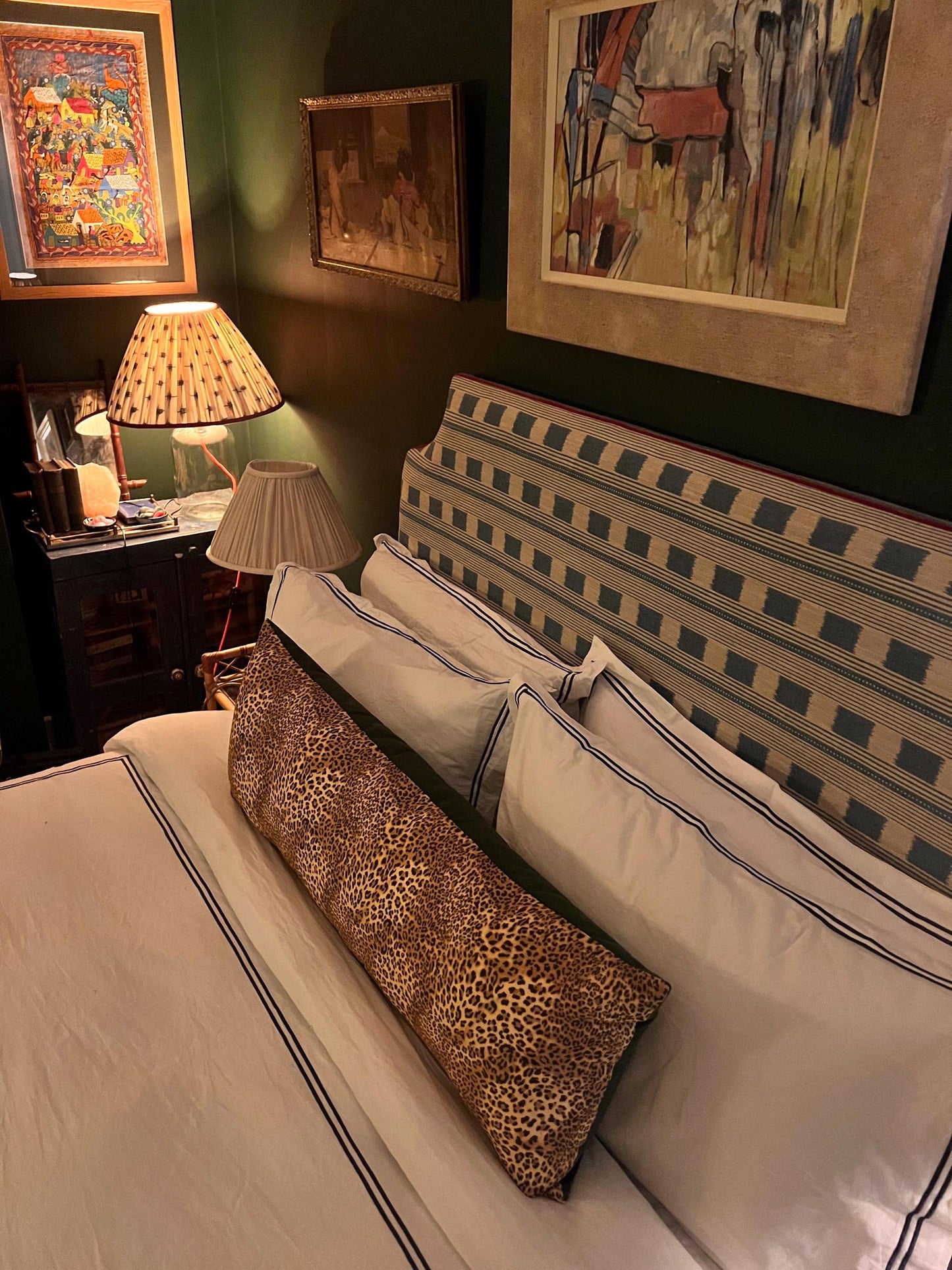 Large leopard print bolster cushions backed with green velvet backing