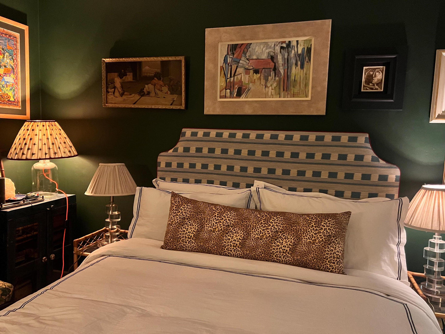 Large leopard print bolster cushions backed with green velvet backing